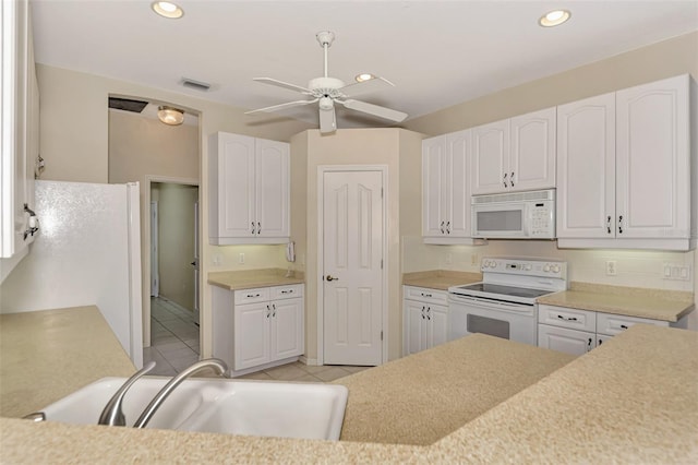 kitchen with white cabinetry, light tile patterned floors, sink, white appliances, and ceiling fan