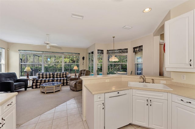 kitchen featuring dishwasher, plenty of natural light, light carpet, and sink