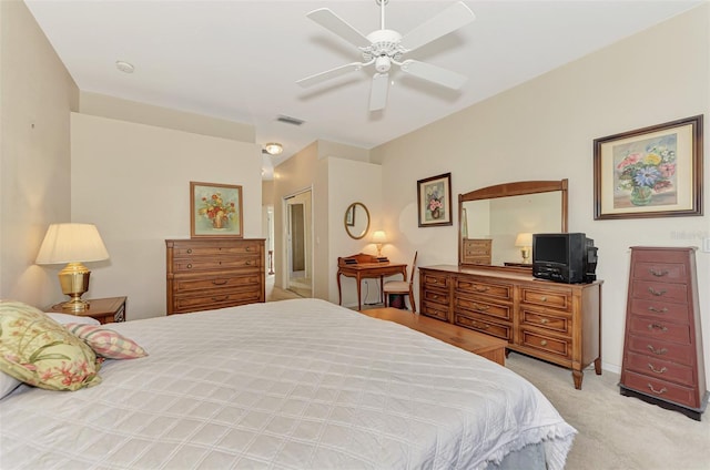 bedroom featuring a closet, light colored carpet, and ceiling fan