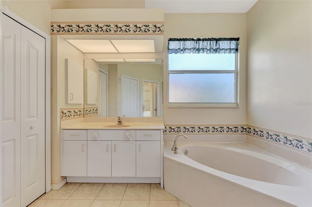 bathroom with vanity, a tub, and tile patterned floors