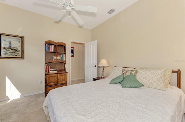 carpeted bedroom with vaulted ceiling and ceiling fan