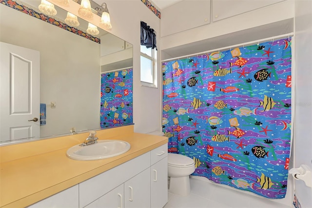 bathroom with vanity, tile patterned flooring, and toilet