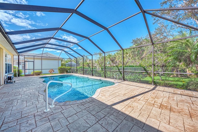 view of swimming pool featuring glass enclosure and a patio