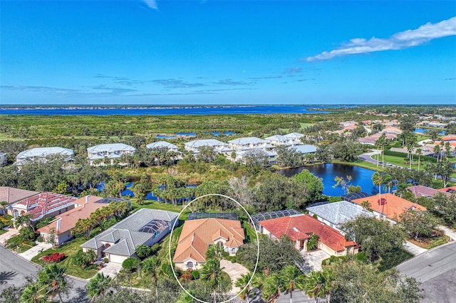 birds eye view of property with a water view