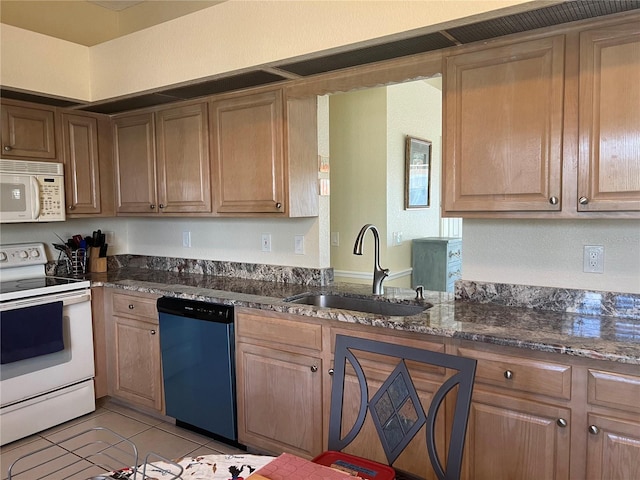 kitchen featuring light tile patterned floors, sink, white appliances, and dark stone countertops