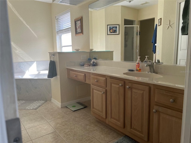 bathroom featuring tile patterned floors, vanity, and separate shower and tub