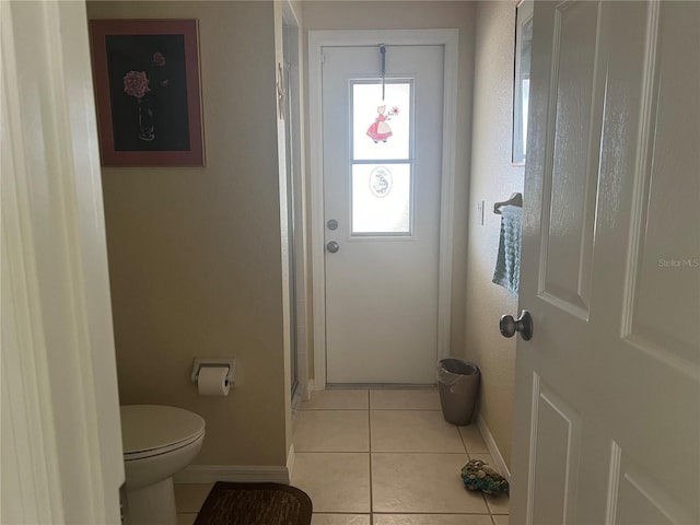 interior space featuring toilet and tile patterned floors