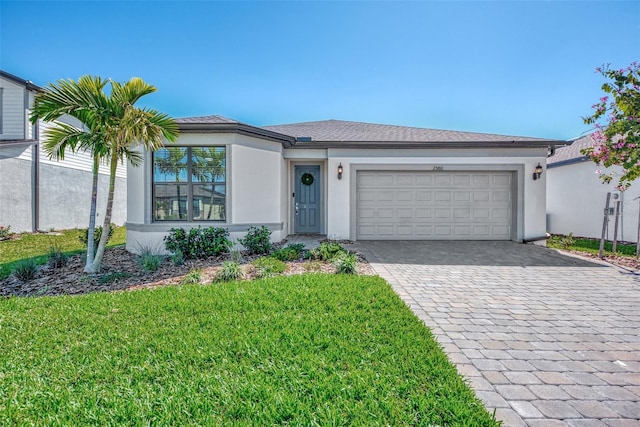 view of front of house featuring a garage and a front yard