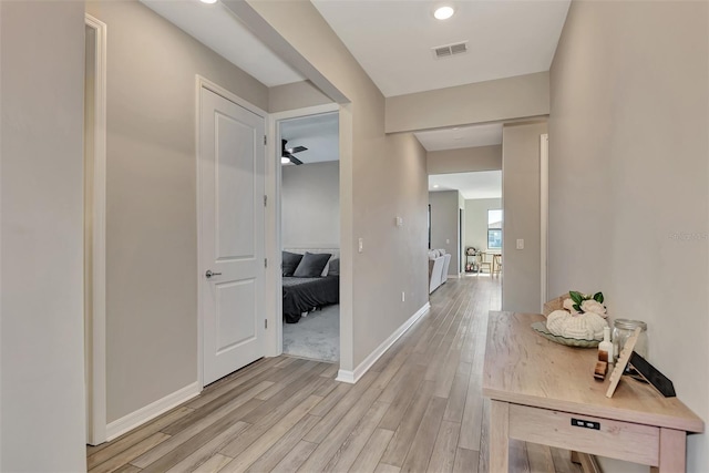 hall with light hardwood / wood-style floors