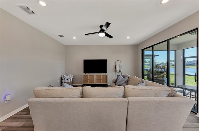 living room with wood-type flooring and ceiling fan