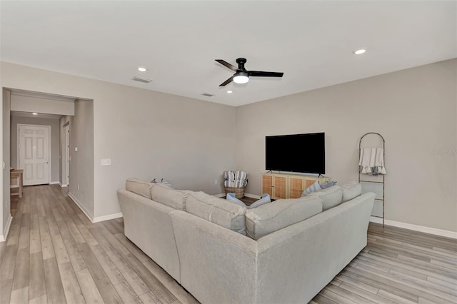 living room with ceiling fan and light wood-type flooring