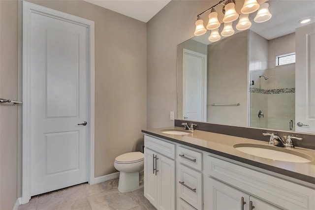 bathroom featuring toilet, tile patterned floors, vanity, and a shower with door