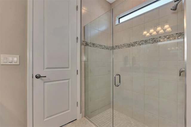 bathroom featuring a shower with door