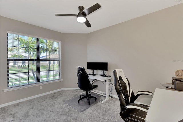 carpeted office featuring ceiling fan