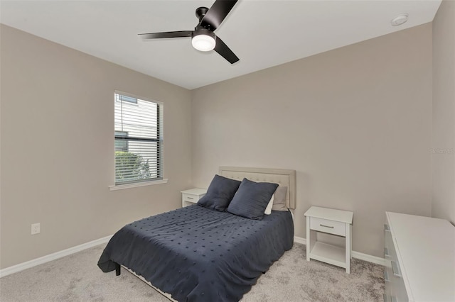 bedroom featuring light carpet and ceiling fan