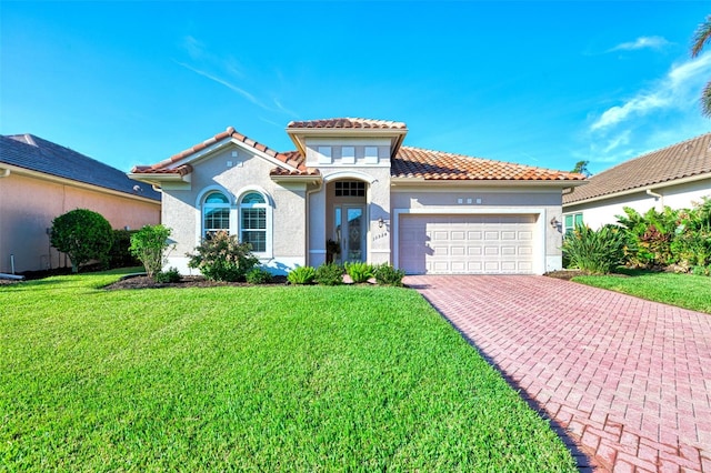 mediterranean / spanish-style house featuring a front yard and a garage