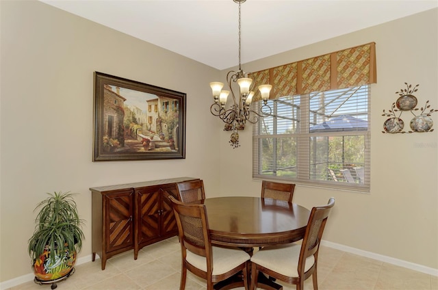 tiled dining space featuring a chandelier