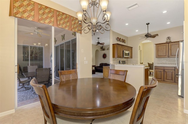 dining area with a chandelier and light tile patterned floors