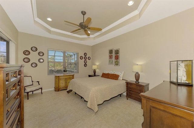 bedroom featuring a tray ceiling, ceiling fan, and crown molding