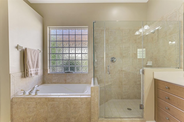 bathroom featuring vanity and shower with separate bathtub