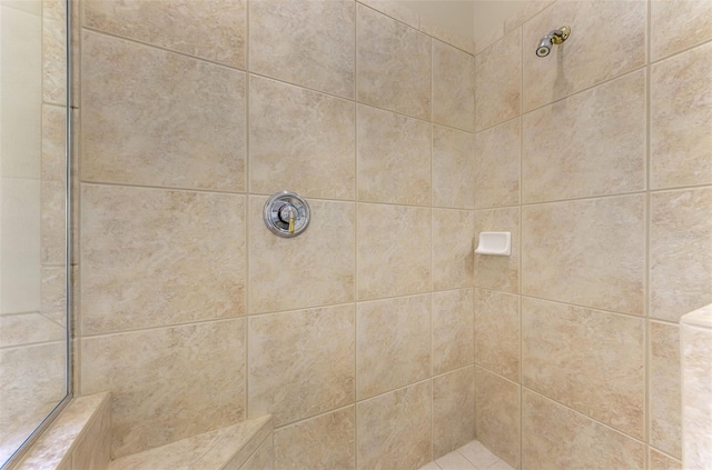 bathroom with a tile shower