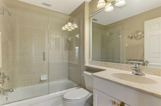 full bathroom with enclosed tub / shower combo, vanity, and toilet