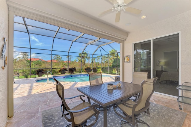 view of patio with glass enclosure and ceiling fan