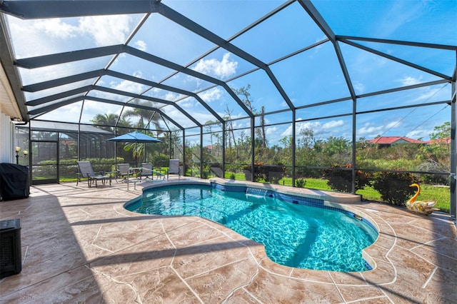 view of swimming pool featuring glass enclosure, grilling area, and a patio