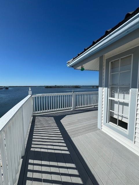 wooden terrace featuring a water view