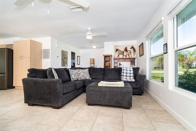 tiled living room with ceiling fan