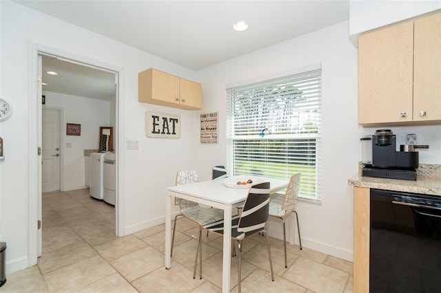 tiled dining area featuring washing machine and dryer and a wealth of natural light