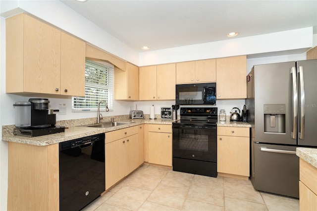 kitchen with light brown cabinets, sink, light tile patterned floors, and black appliances