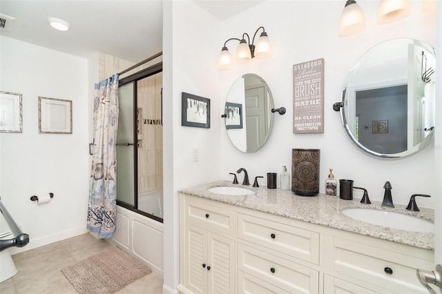 bathroom featuring tile patterned floors, tiled shower / bath combo, and vanity