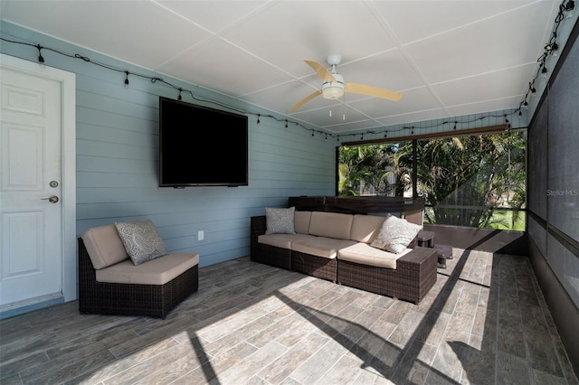 sunroom featuring ceiling fan