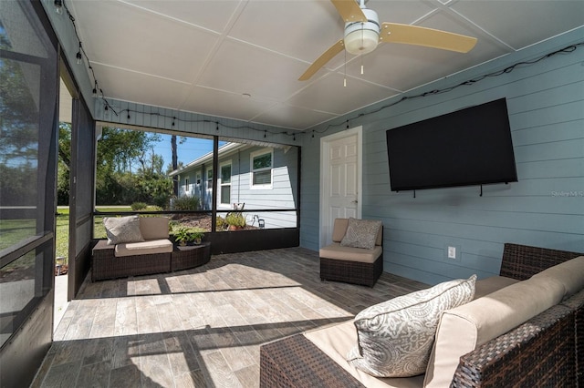 sunroom featuring ceiling fan