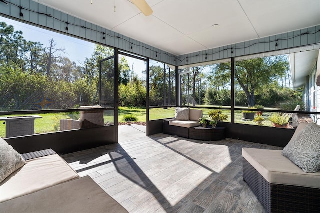 sunroom featuring ceiling fan