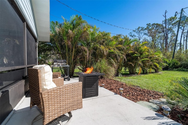 view of patio / terrace with grilling area and an outdoor fire pit