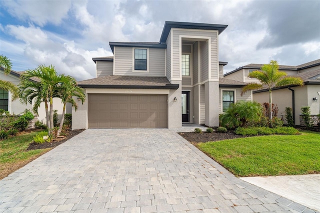 view of front of property with a shingled roof, a front lawn, stucco siding, decorative driveway, and a garage