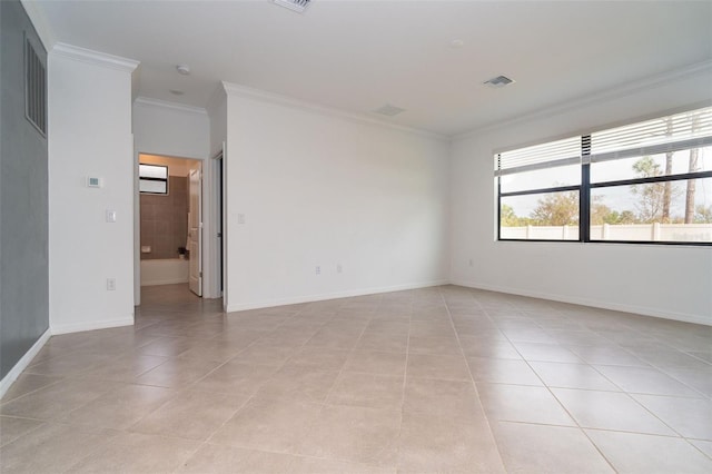 empty room featuring light tile patterned floors, visible vents, baseboards, and crown molding