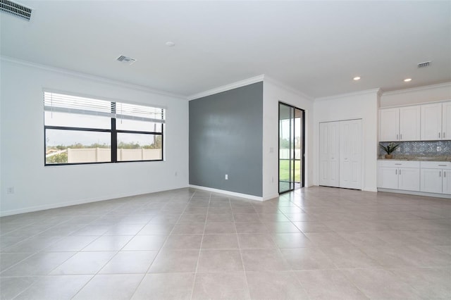 interior space featuring light tile patterned flooring and ornamental molding