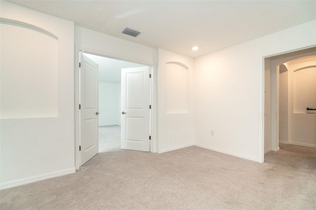 unfurnished room featuring light colored carpet