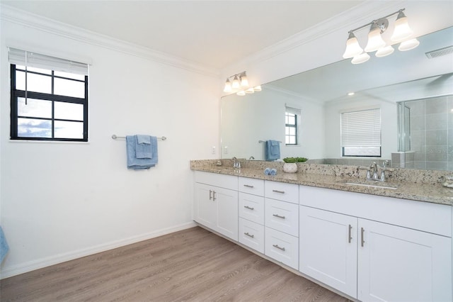 bathroom featuring an enclosed shower, vanity, wood-type flooring, and ornamental molding