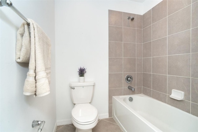 bathroom featuring toilet, tiled shower / bath, and tile patterned flooring