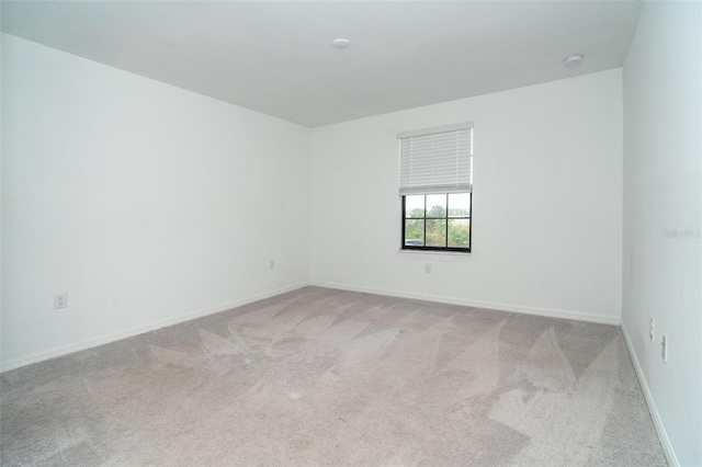 empty room featuring light colored carpet