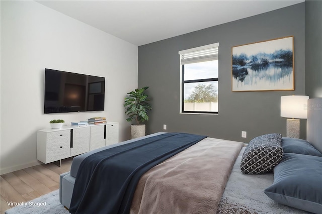 bedroom featuring baseboards and wood finished floors