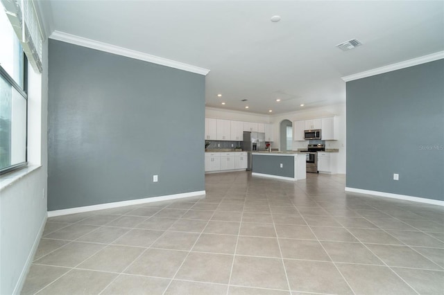 unfurnished living room with visible vents, baseboards, and ornamental molding