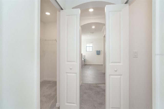 hallway featuring recessed lighting, arched walkways, and carpet floors