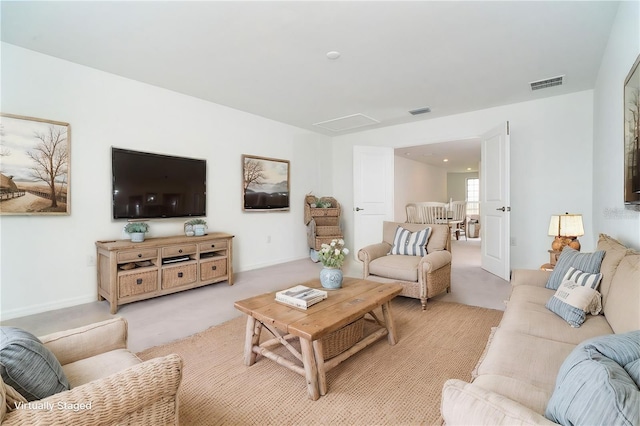 living room featuring visible vents and light carpet