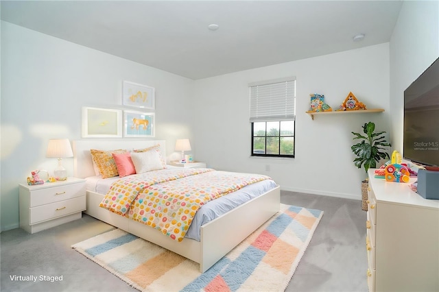 bedroom with light colored carpet and baseboards