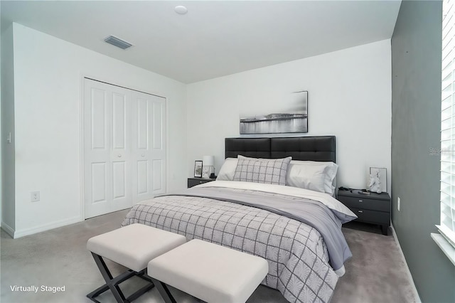 bedroom with concrete floors, baseboards, visible vents, and a closet